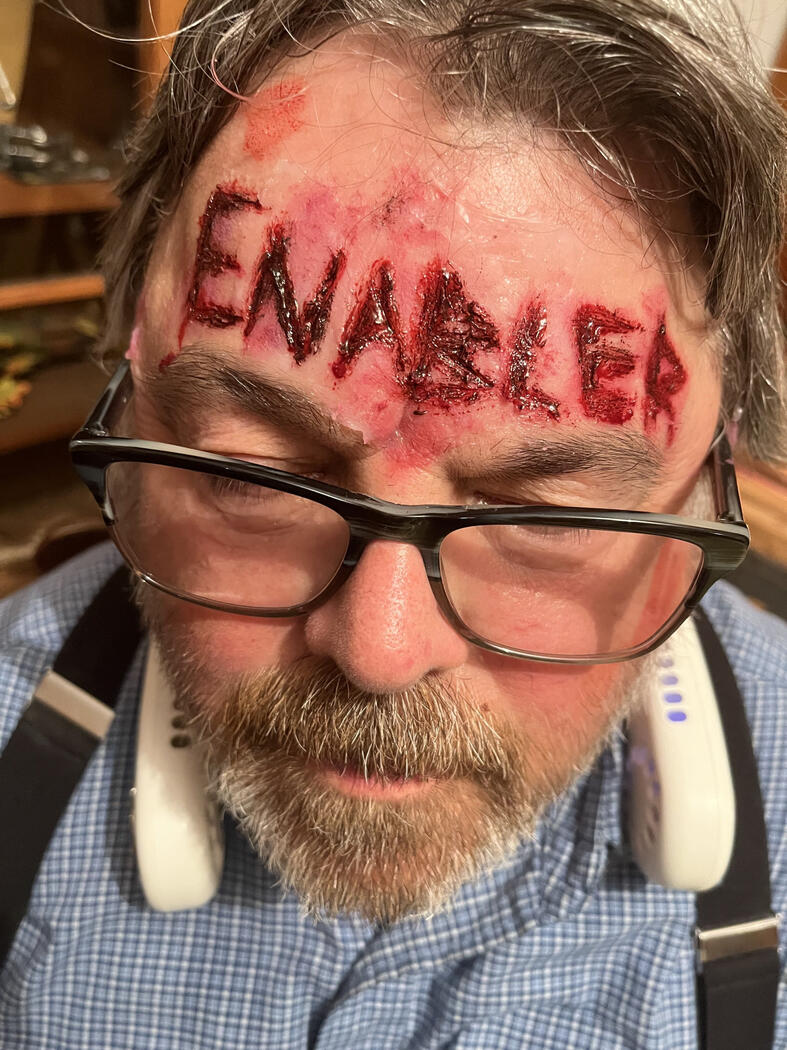 'Enabler' written on forehead